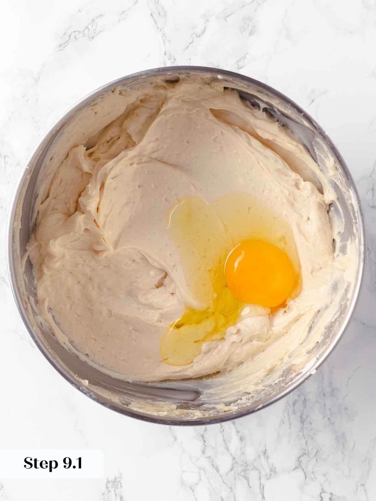 Adding eggs during the pumpkin cheesecake preparation.