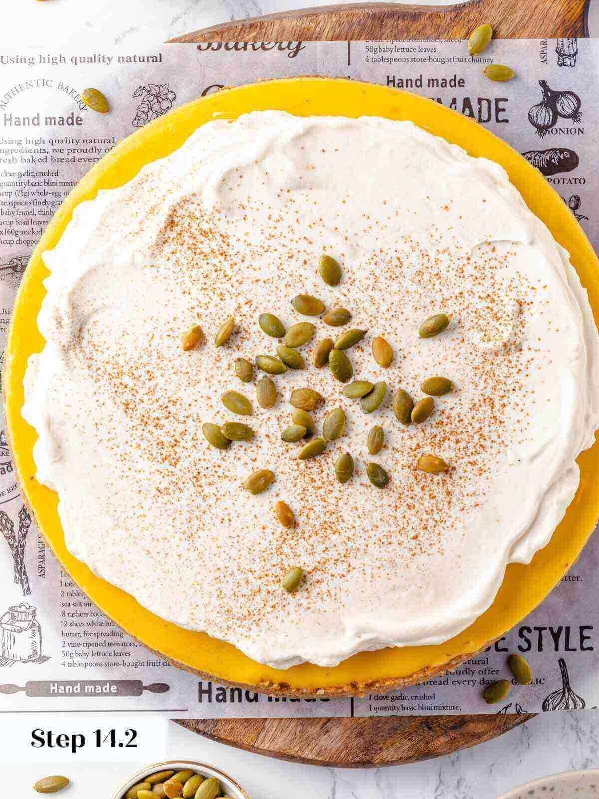 Pumpkin cheesecake topped with whipped cream during the process.