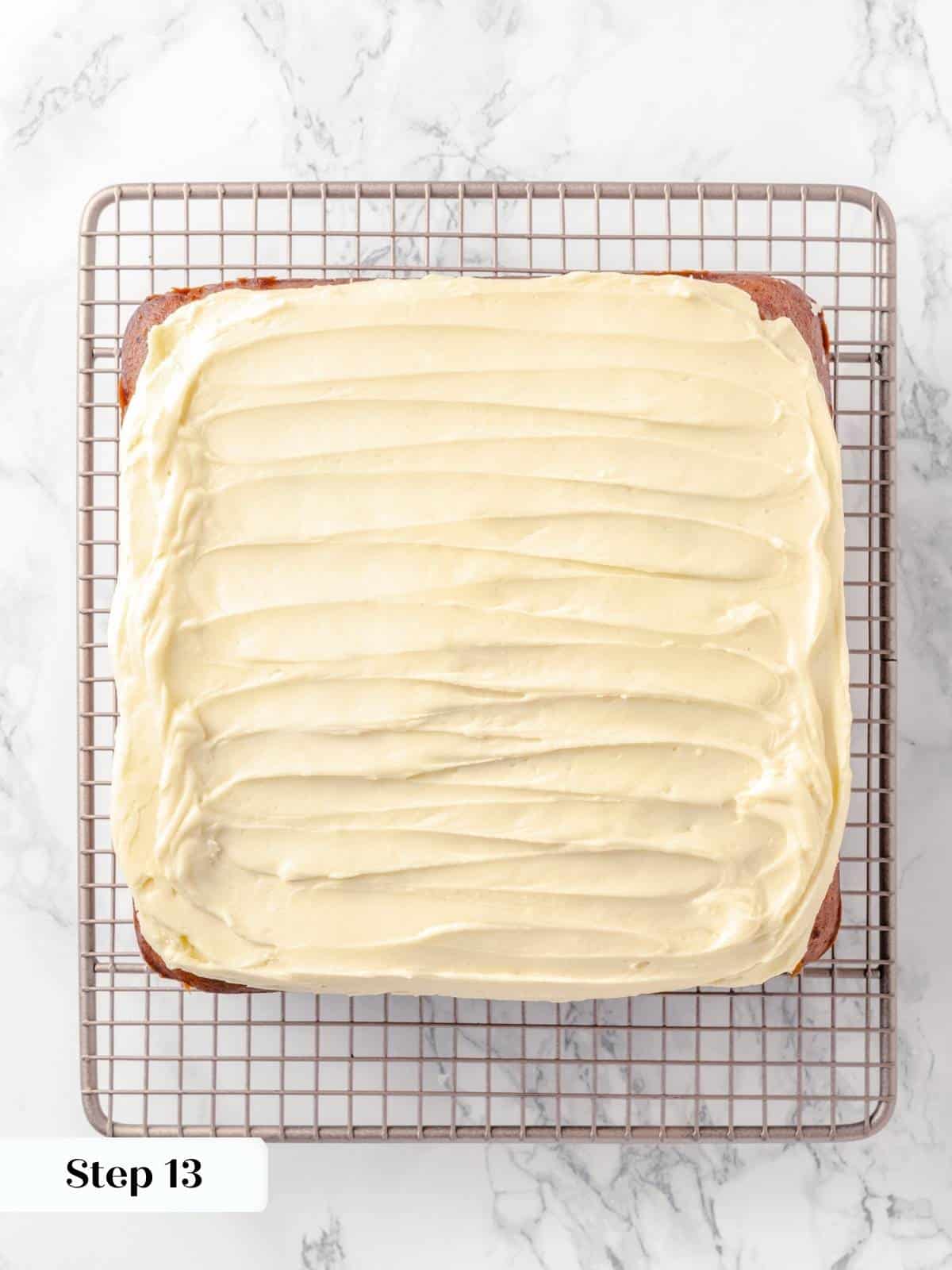 Frosted applesauce cake cooling on a wire rack.