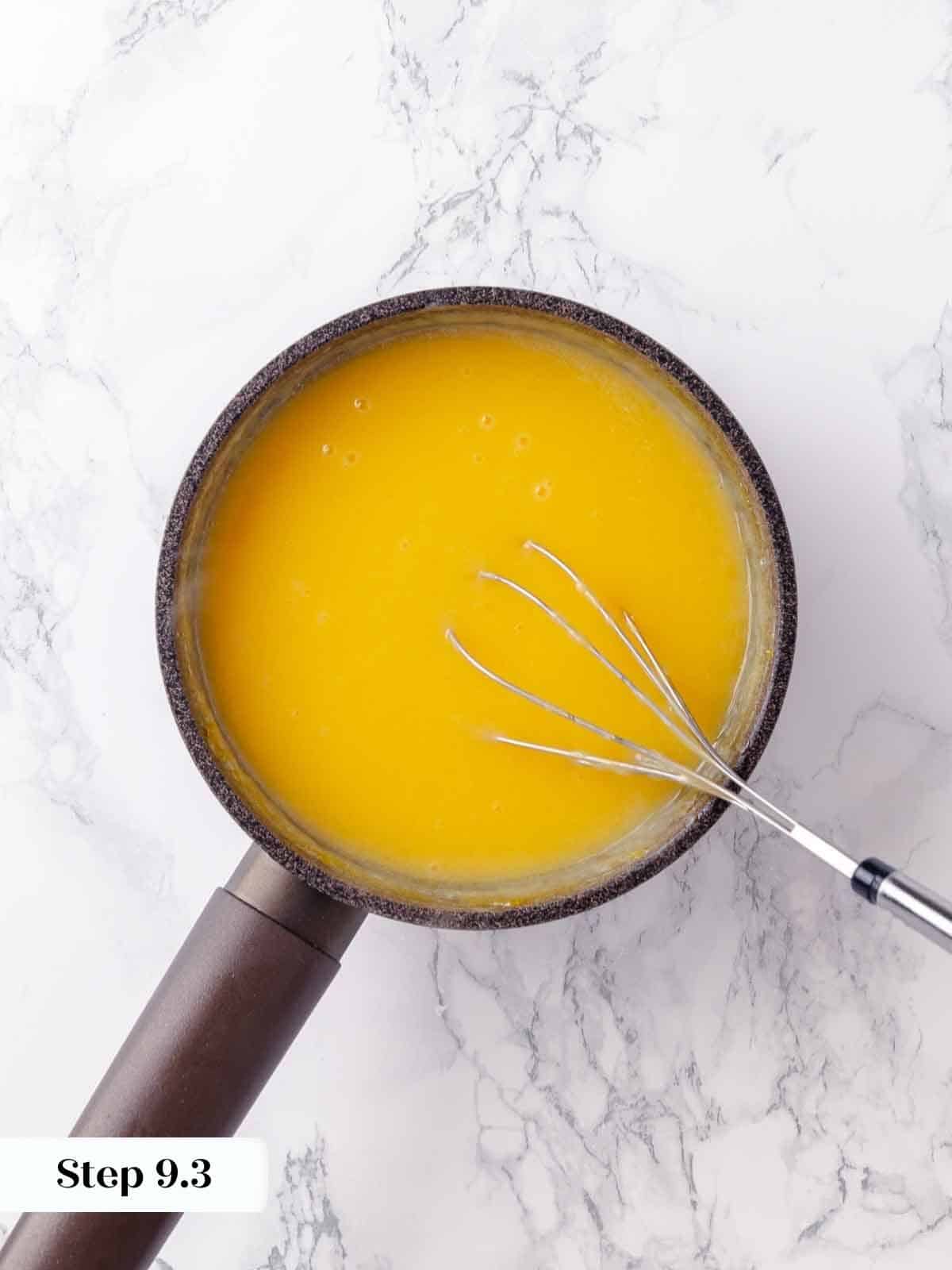 Lemon pie filling simmering in a pot on the stove, rich and thick.