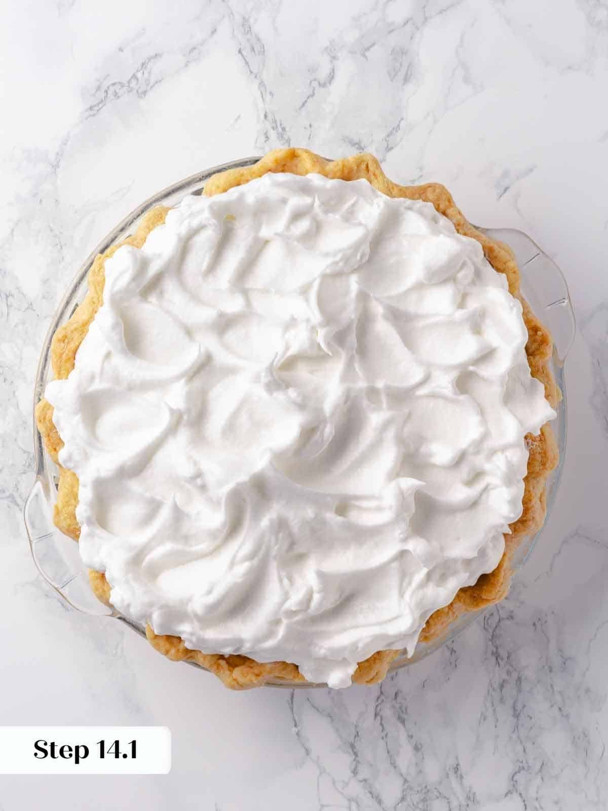 A French-style meringue, unbaked, swirled in decorative peaks on a pie.