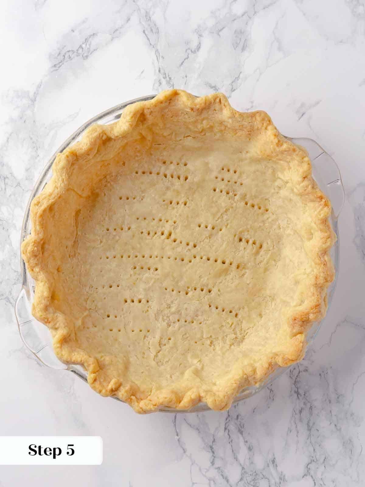 A golden brown, par-baked pie crust, perfectly crisp and ready for filling.