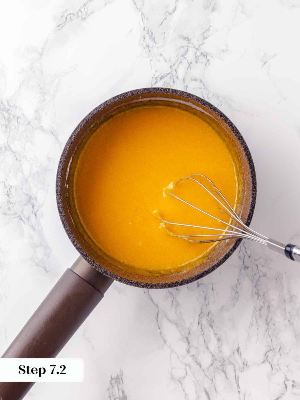 Whisked egg yolks, smooth and pale yellow, prepared for mixing into the filling.