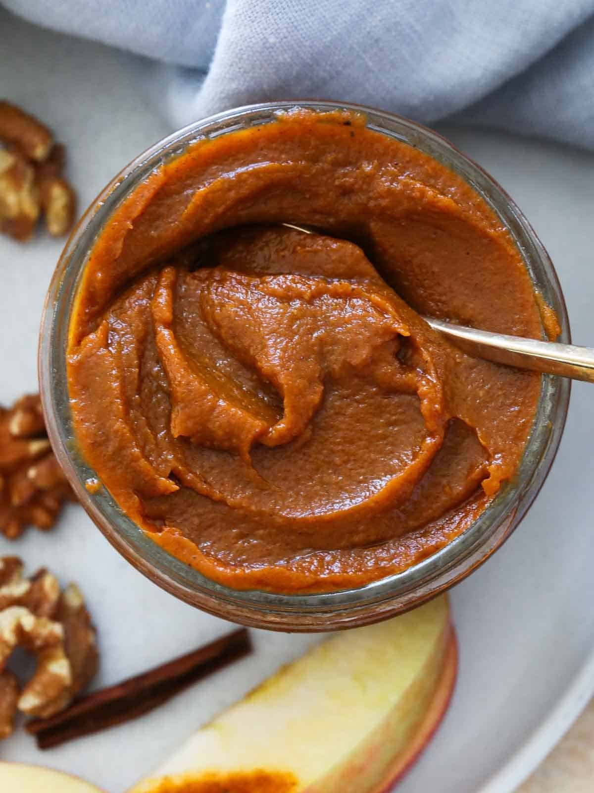 spoon in jar of pumpkin butter.