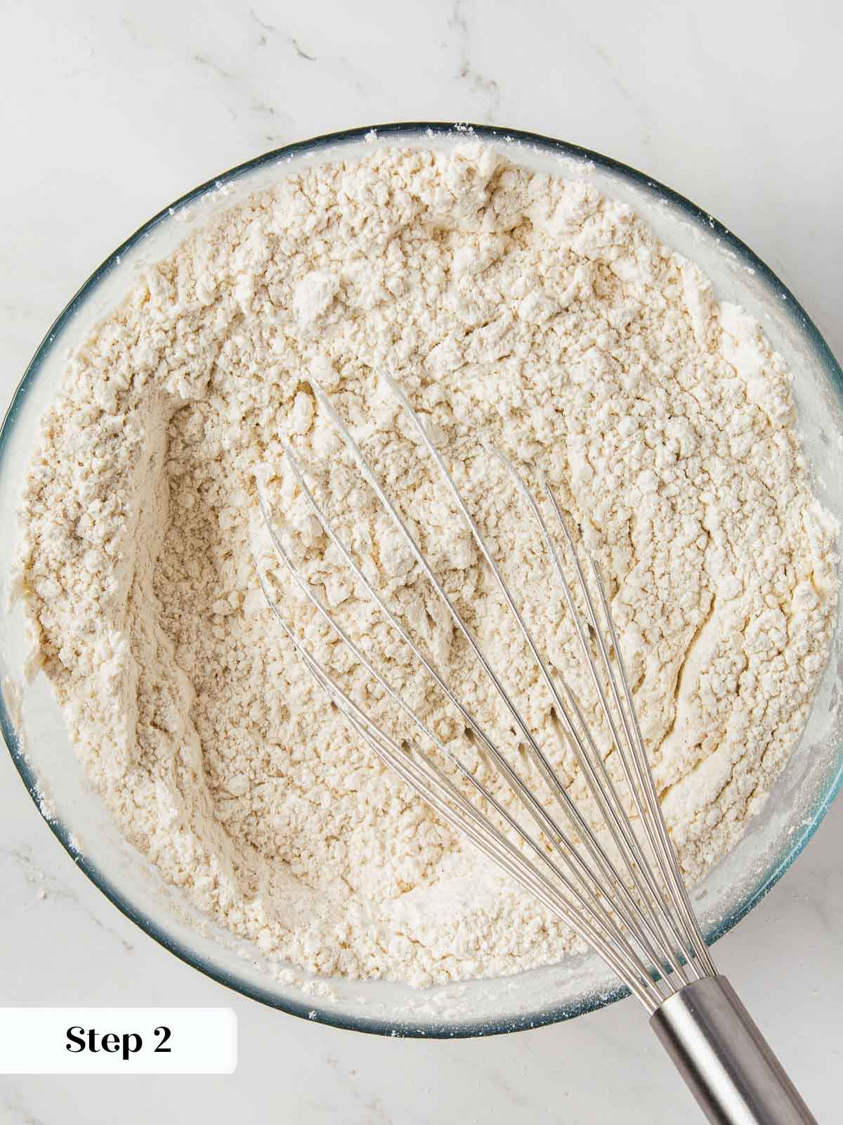 Dry ingredients for pumpkin bread being whisked together in a bowl.