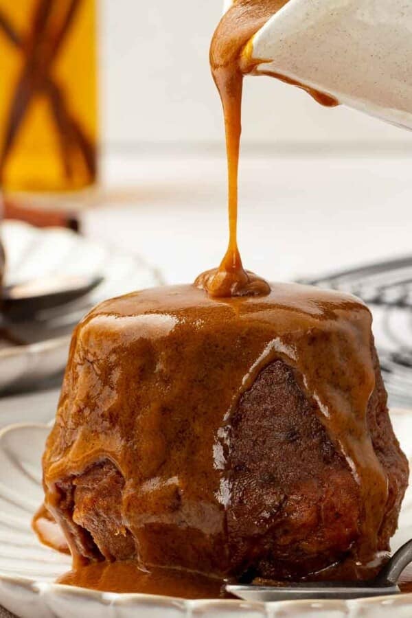 Sticky toffee pudding fully soaked in rich toffee sauce.