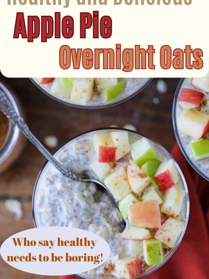 A glass filled with creamy overnight oats and apple toppings.