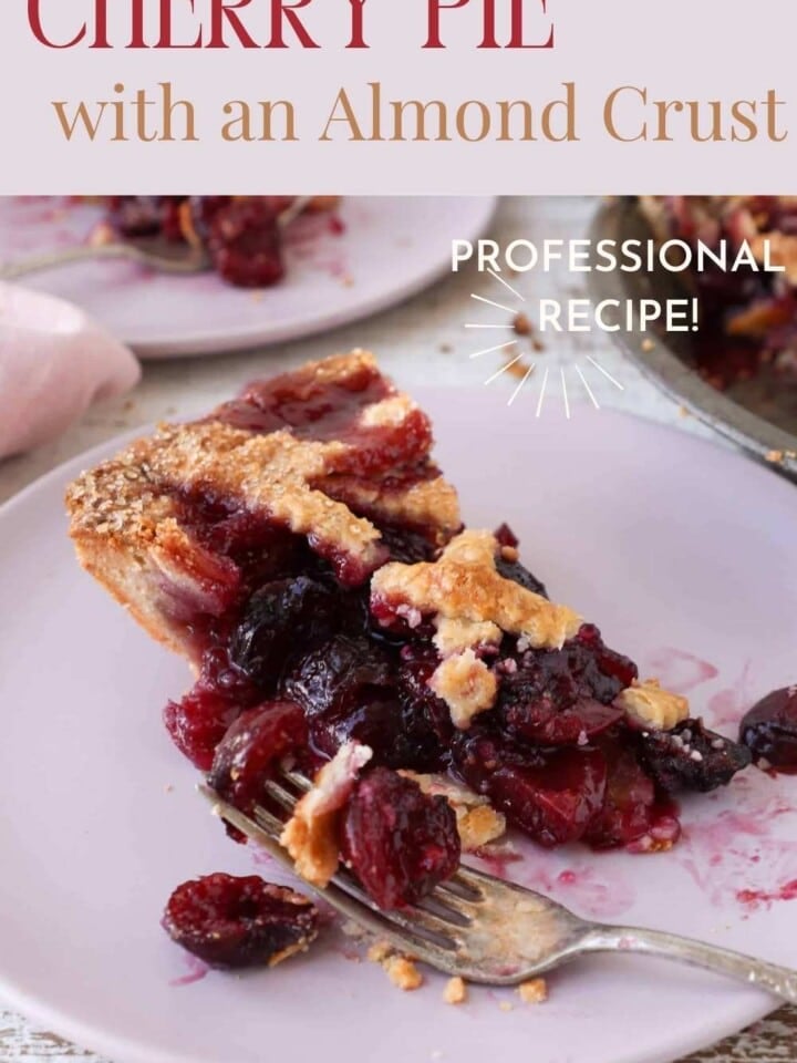 Close-up of a cherry pie slice highlighting its almond crust and vibrant cherry filling on a rustic table.