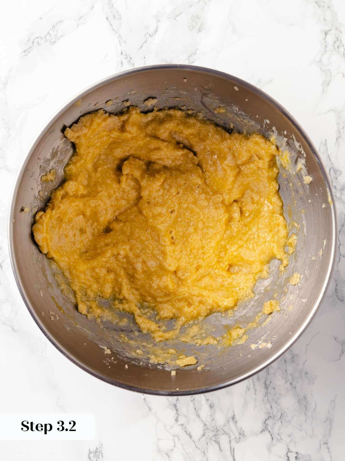 Vanilla extract being poured into the wet ingredients for hermit cookie dough.