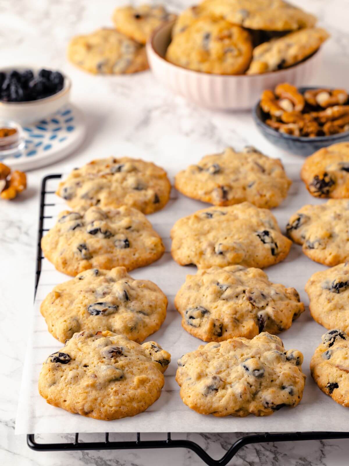 Hermit cookies lined up neatly on a wire rack, cooling.