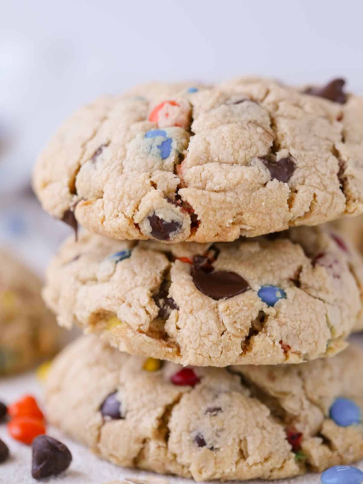 A stack of three thick monster cookies, highlighting their chunky texture.