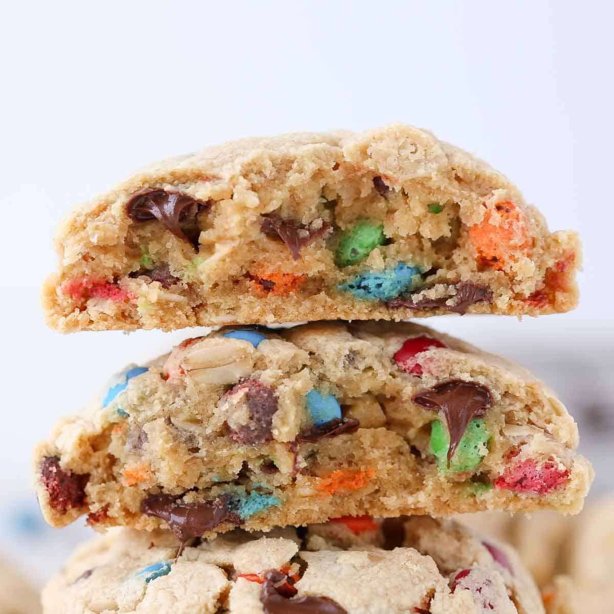 A close-up of a thick monster cookie, emphasizing its hearty, chewy layers.