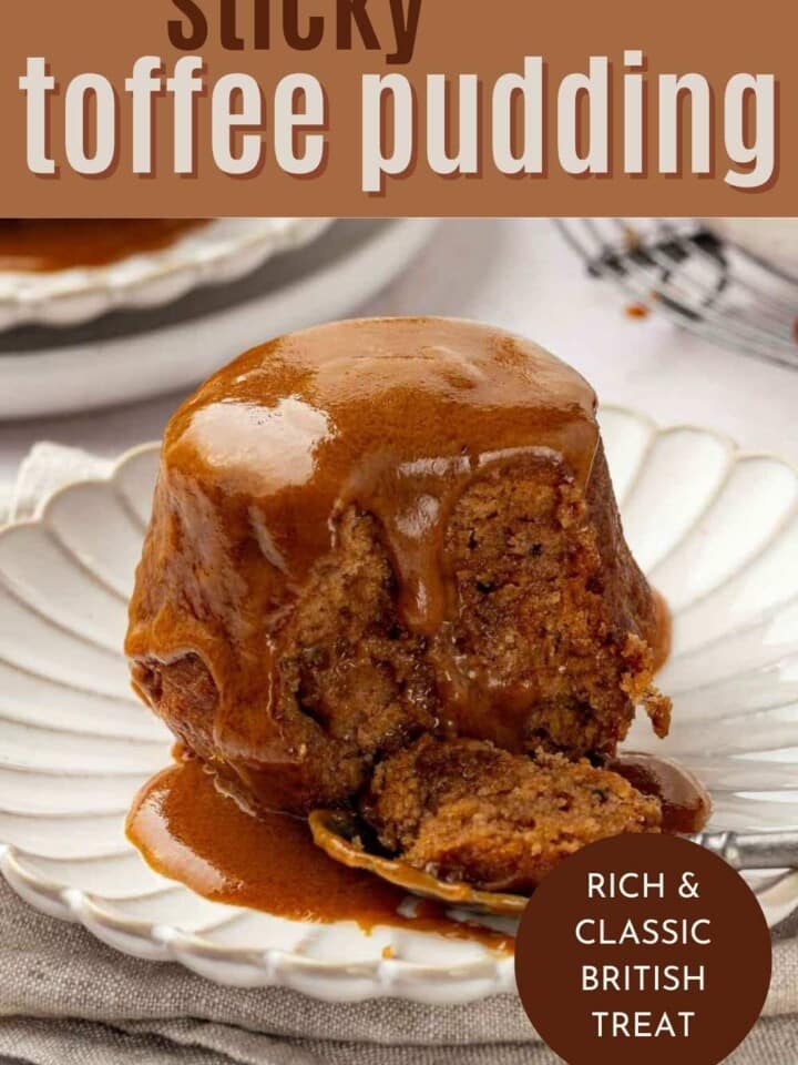 Close-up of sticky toffee pudding with rich toffee sauce soaking into the soft cake.