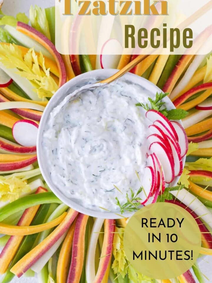 Tzatziki sauce served in a small bowl garnished with fresh dill.