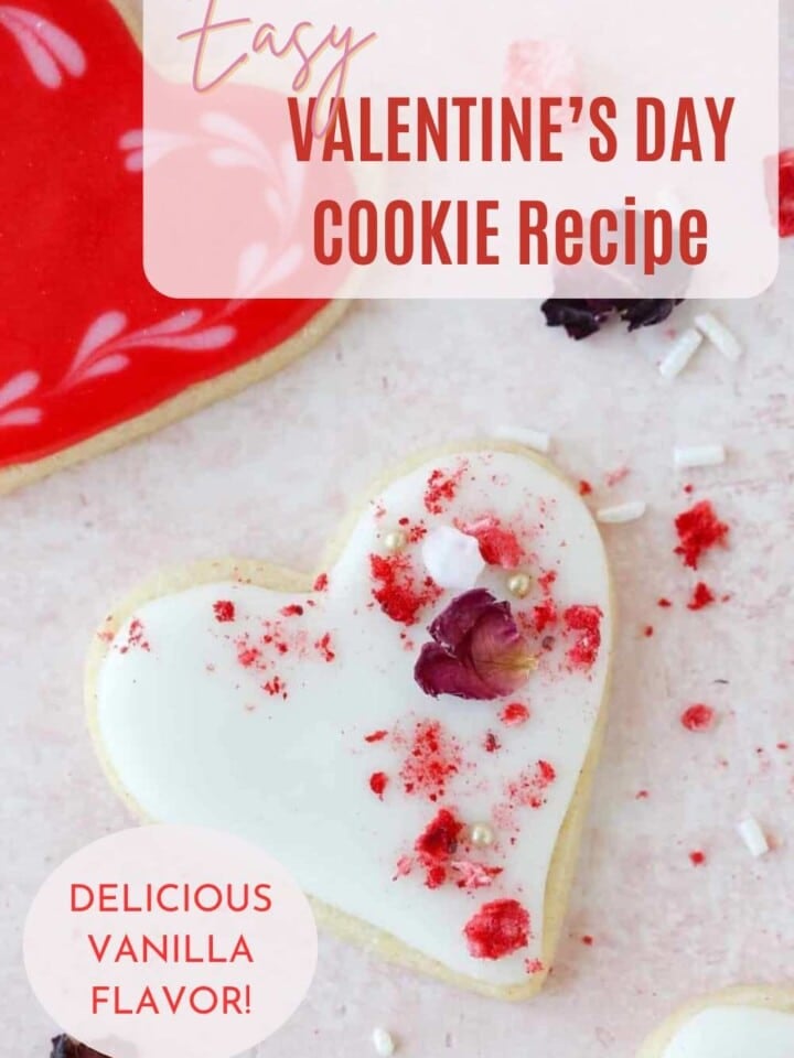 Close-up of a Valentine’s cookie with white icing and white sugar pearls, perfect for gifting.