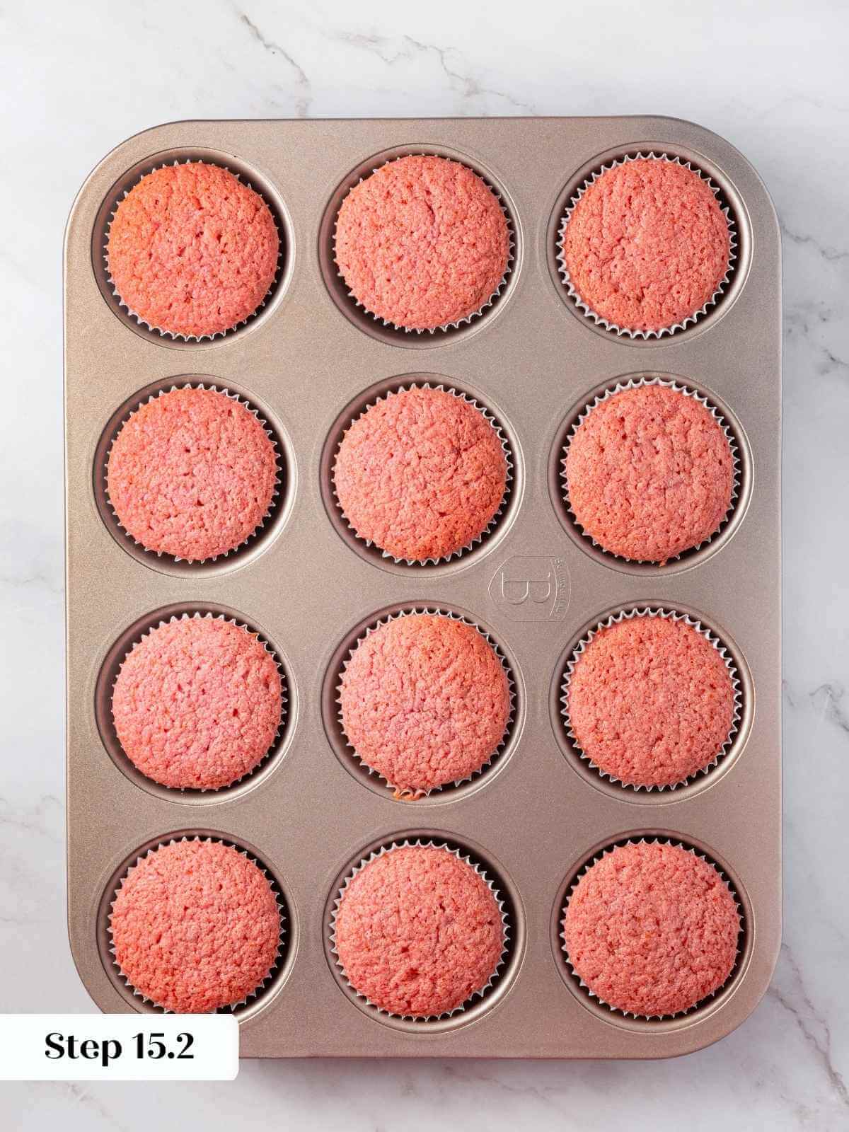 A tray of freshly baked strawberry cupcakes.