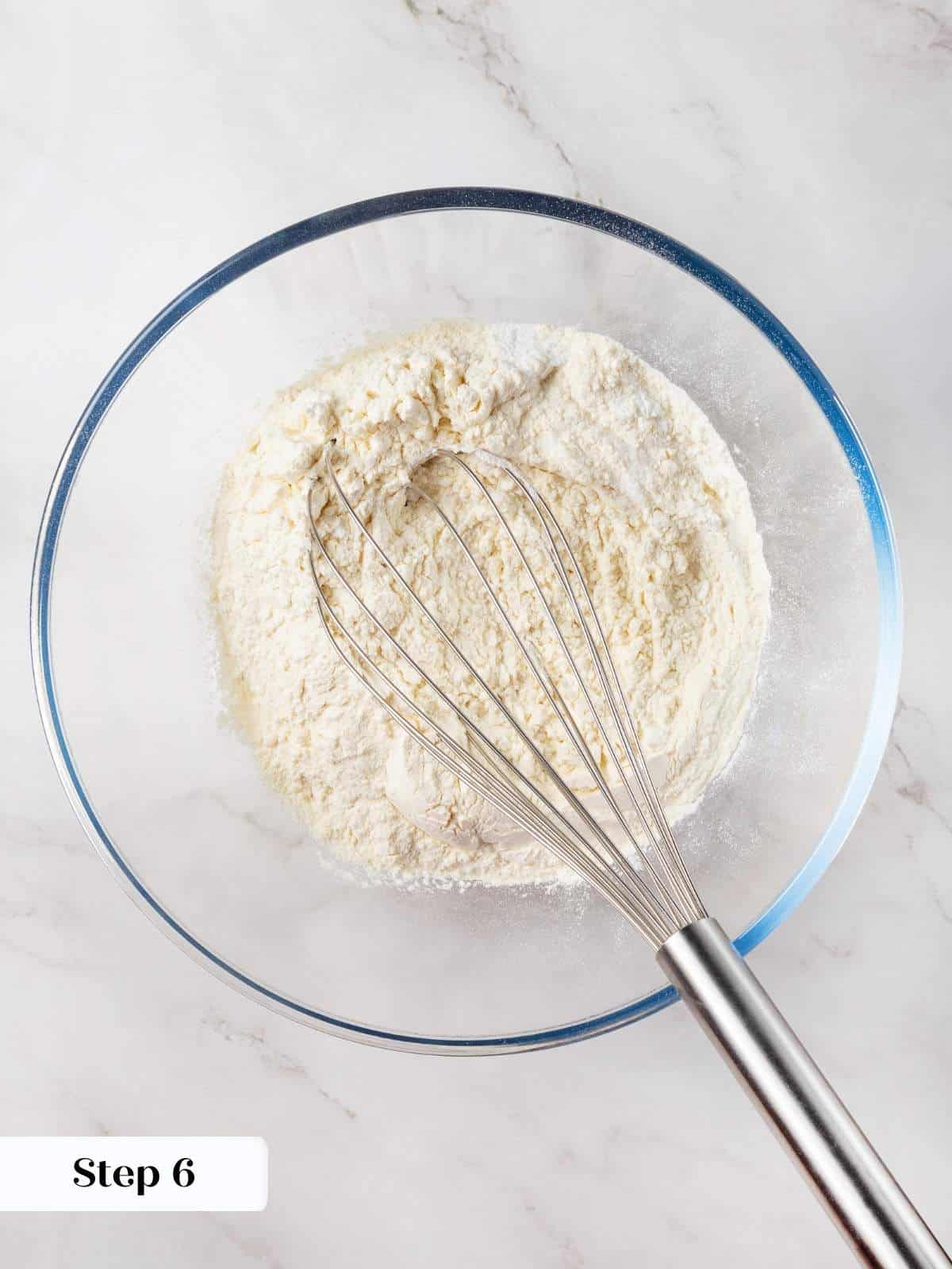 Dry ingredients for strawberry cupcakes being whisked together to ensure even distribution.