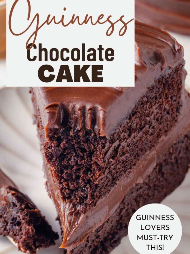 A decadent Guinness stout chocolate cake slice with creamy caramel chocolate frosting, served on a white plate.