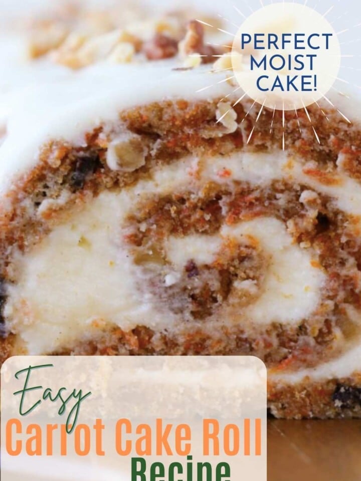 Carrot cake roll with visible shredded carrots, raisins, and walnuts served on a rustic plate.