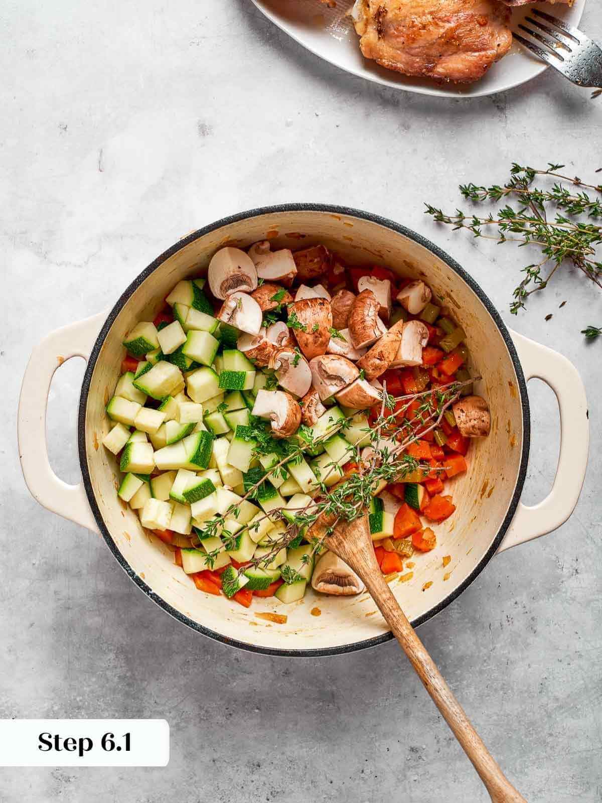 fresh zucchini pieces added to the vegetable soup.