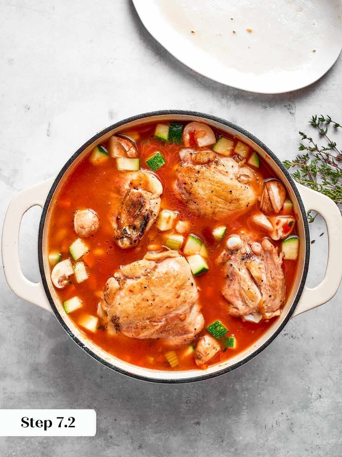 Image showing chicken thighs incorporated into the soup pot.