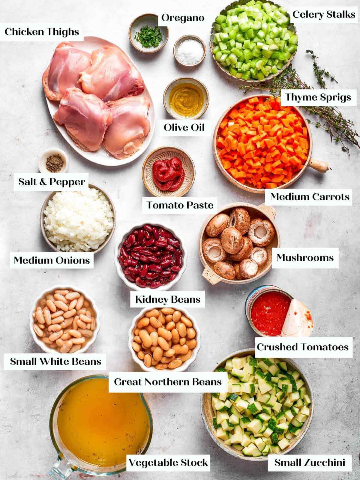 all soup ingredients arranged on a white marble countertop.