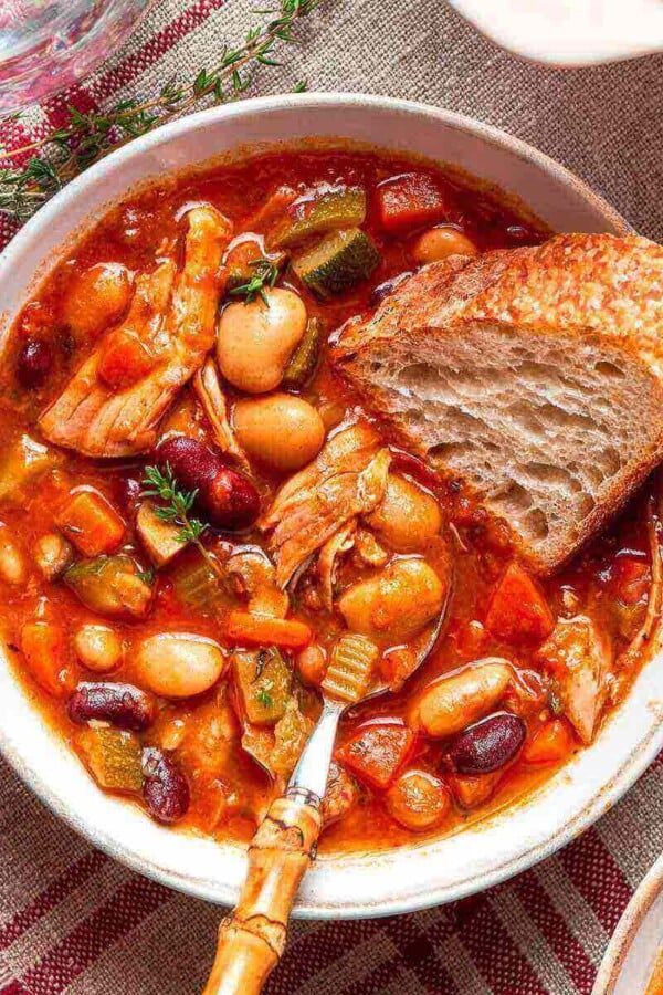 a generous serving of chicken soup in a bowl.