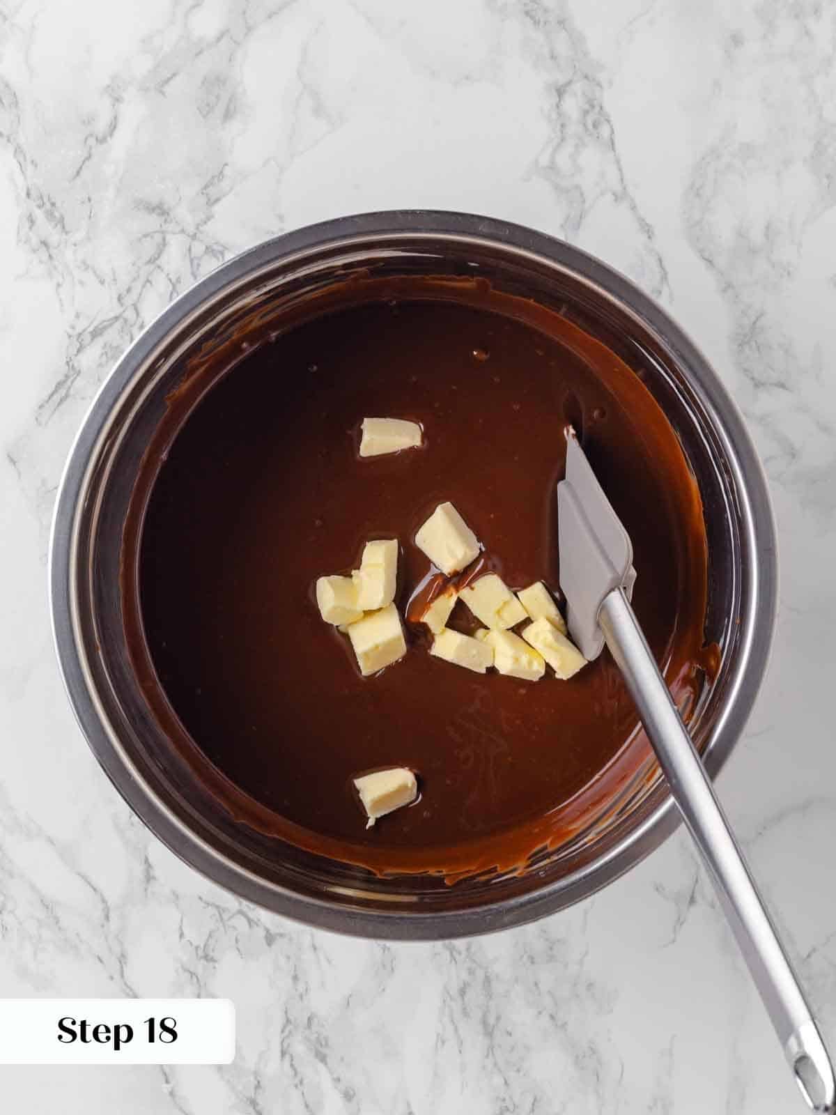 adding butter to hot ganache for frosting.