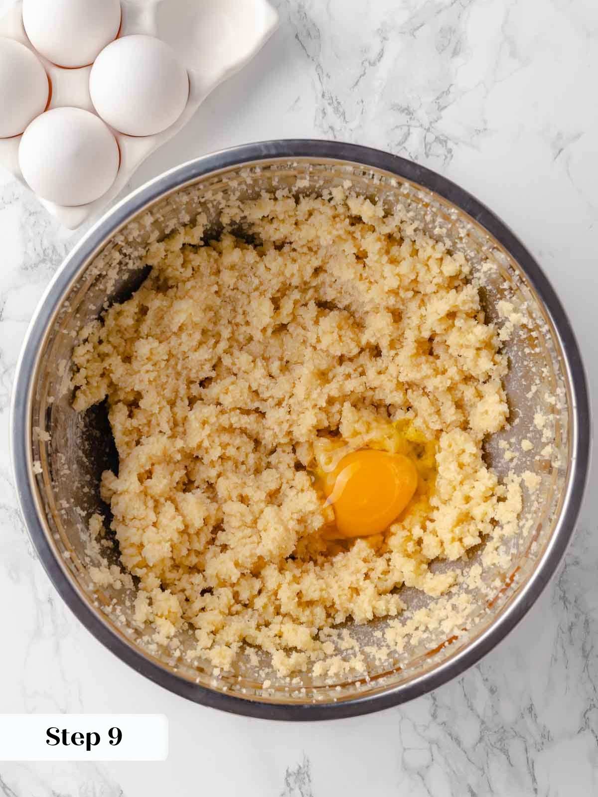 adding eggs to creamed butter and sugar for guinness cake.