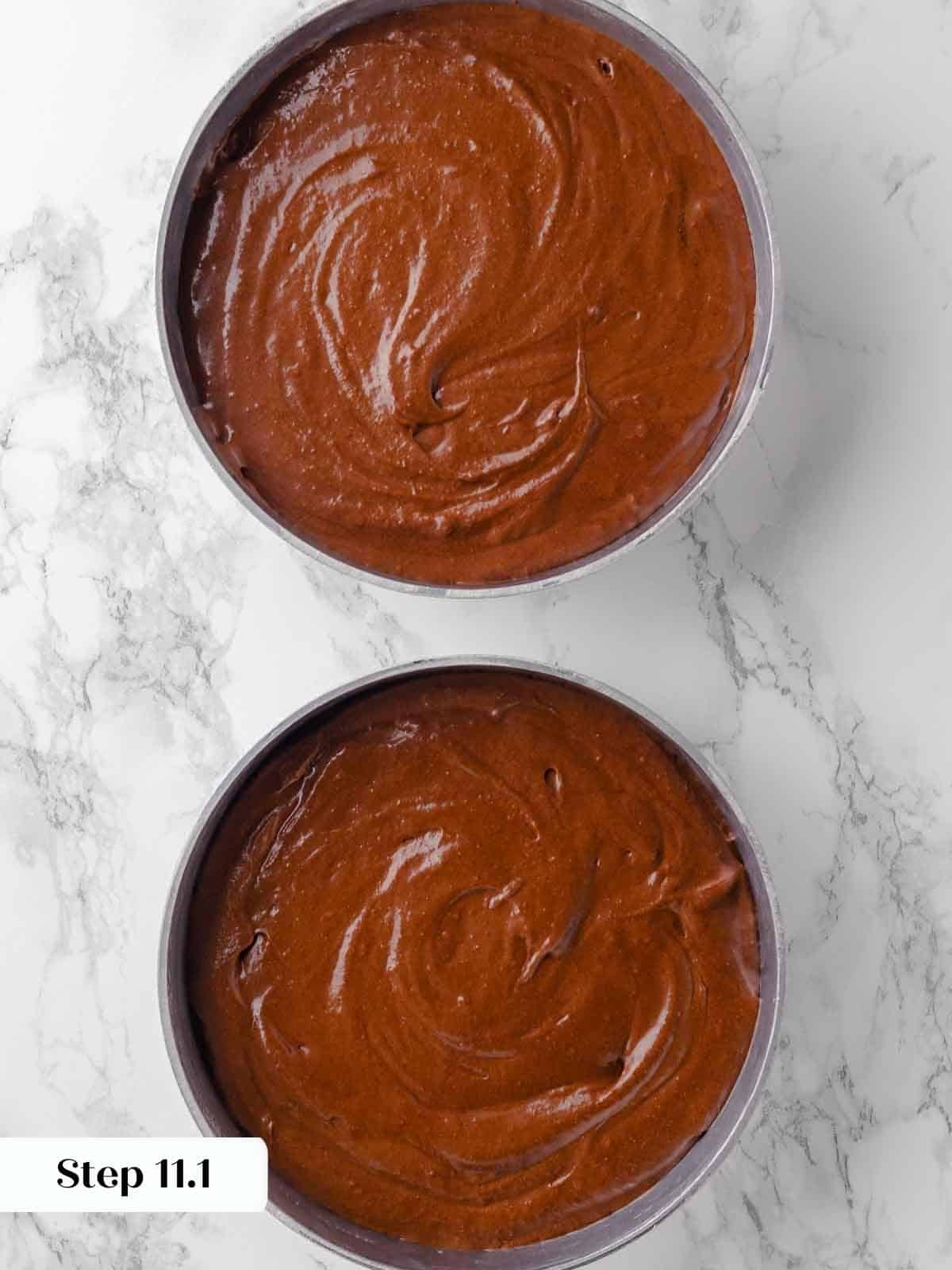 guinness chocolate cake batter divided between two prepared pans.