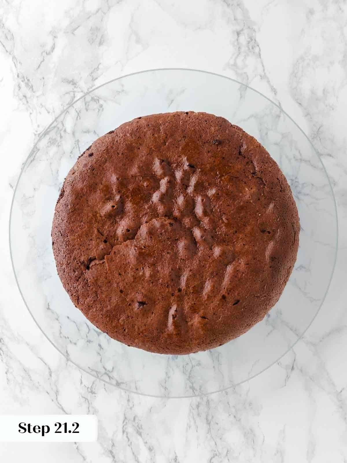 cooled cake layer on cake stand.