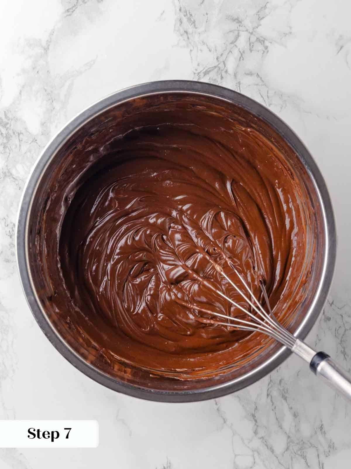 whisking in sour cream to guinness ganache mixture for cake batter.