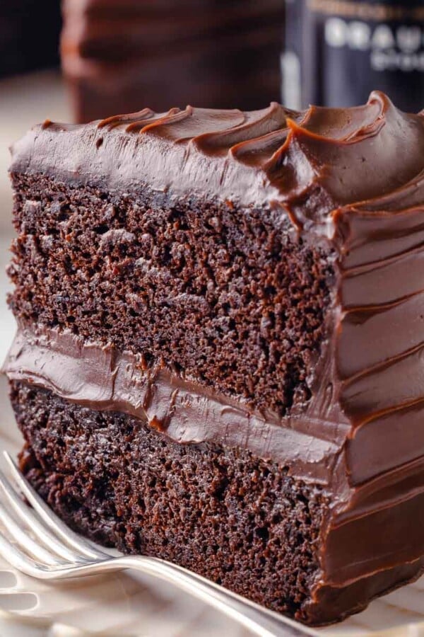 slice of guinness chocolate cake with two layers on plate with fork.