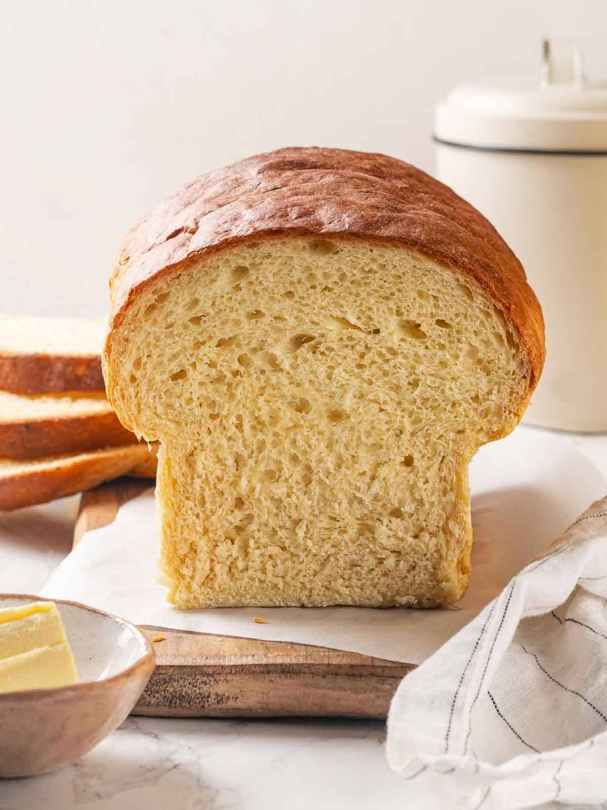 Crispy, beautifully baked crust on a loaf of homemade potato bread.