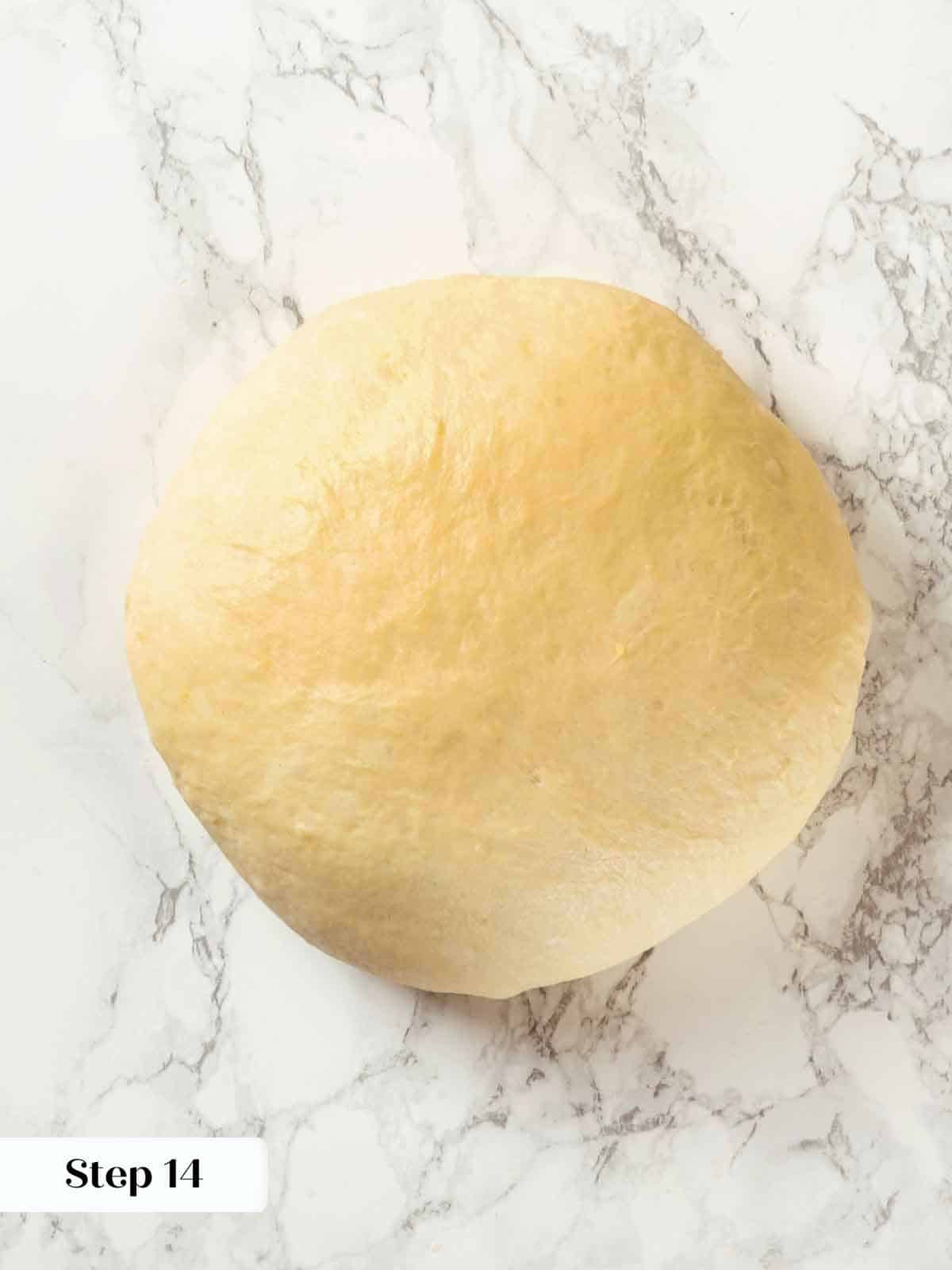 A round ball of potato bread dough resting before final shaping.