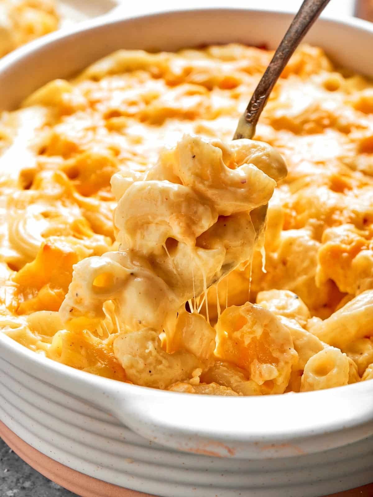 A deep casserole dish filled with creamy, cheesy baked mac and cheese.