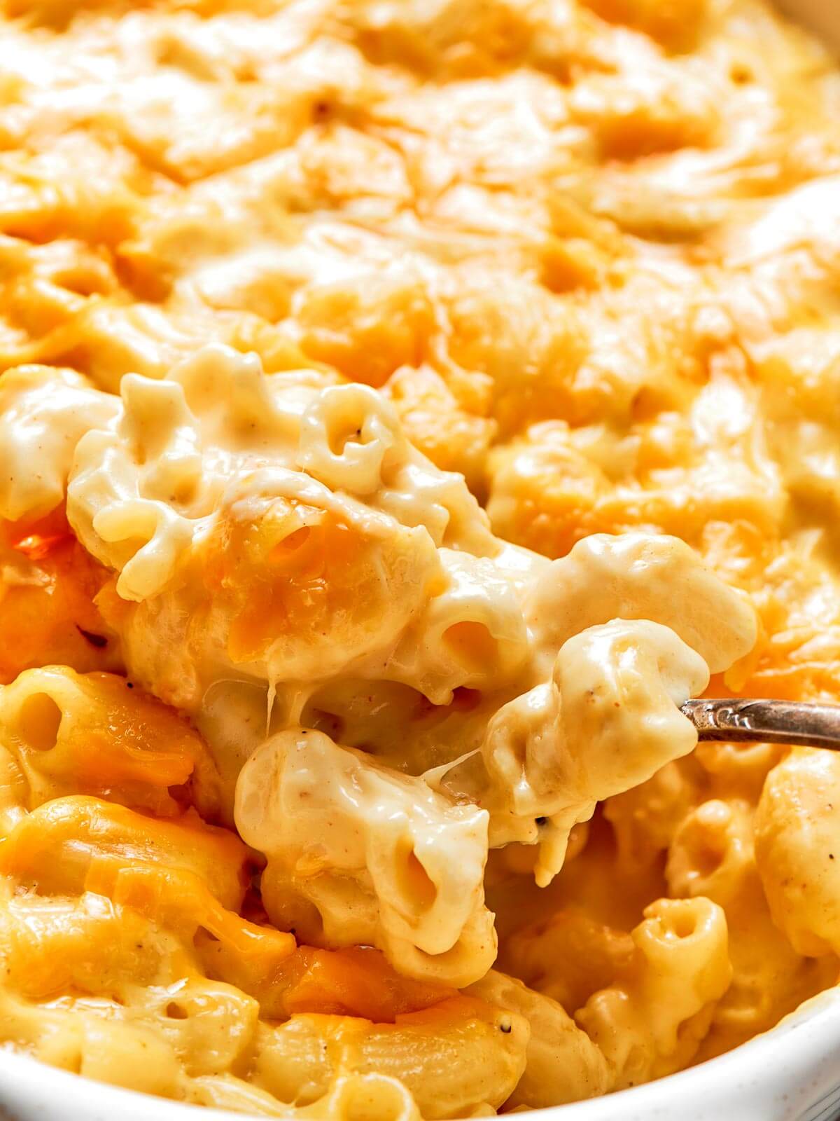 A bubbling dish of baked mac and cheese with a golden, crispy top.