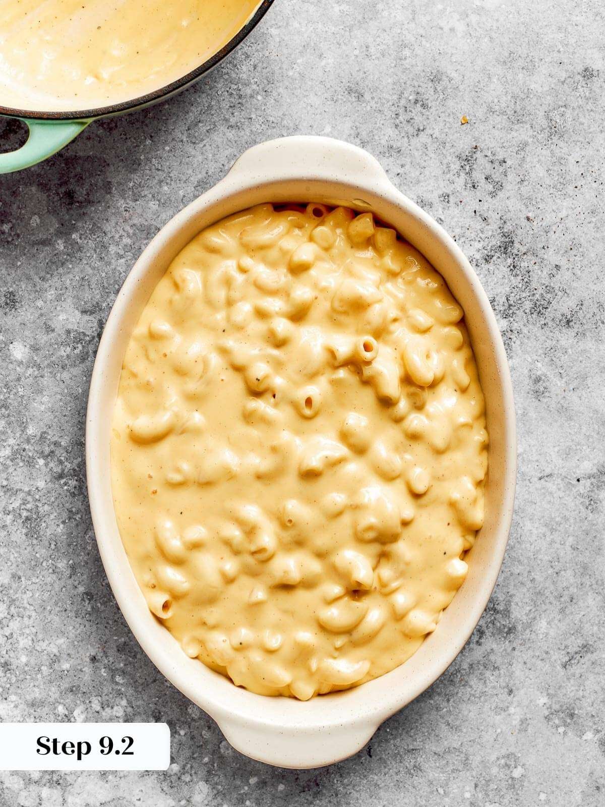 Elbow macaroni in a baking dish covered in sauce.