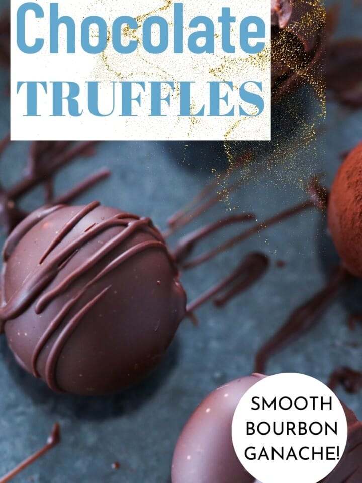 A batch of homemade bourbon chocolate truffles on a counter, with some dusted in cocoa powder and others coated in chocolate.