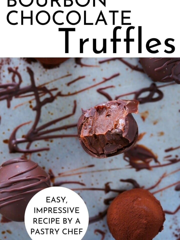 drizzling melted chocolate over freshly rolled bourbon truffles on a parchment sheet.