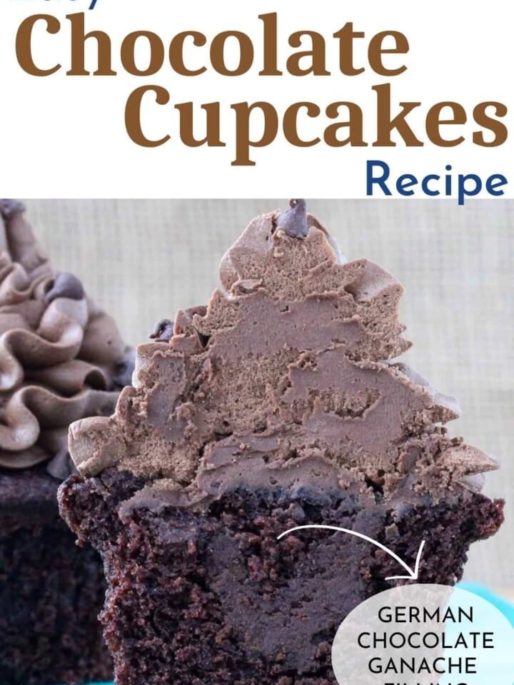 A batch of homemade chocolate cupcakes with smooth chocolate buttercream and a rich ganache filling, sitting on a blue surface.