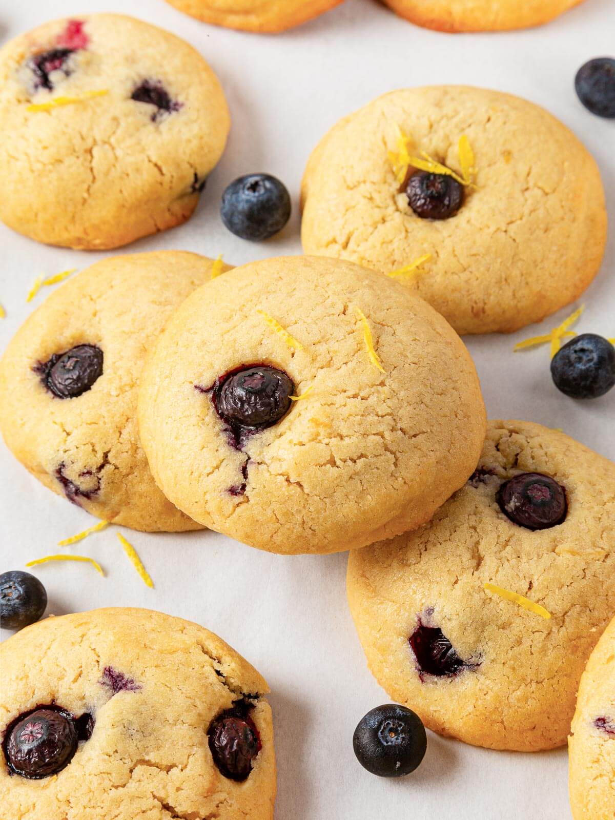 Several lemon blueberry cookies displayed together on a countertop.