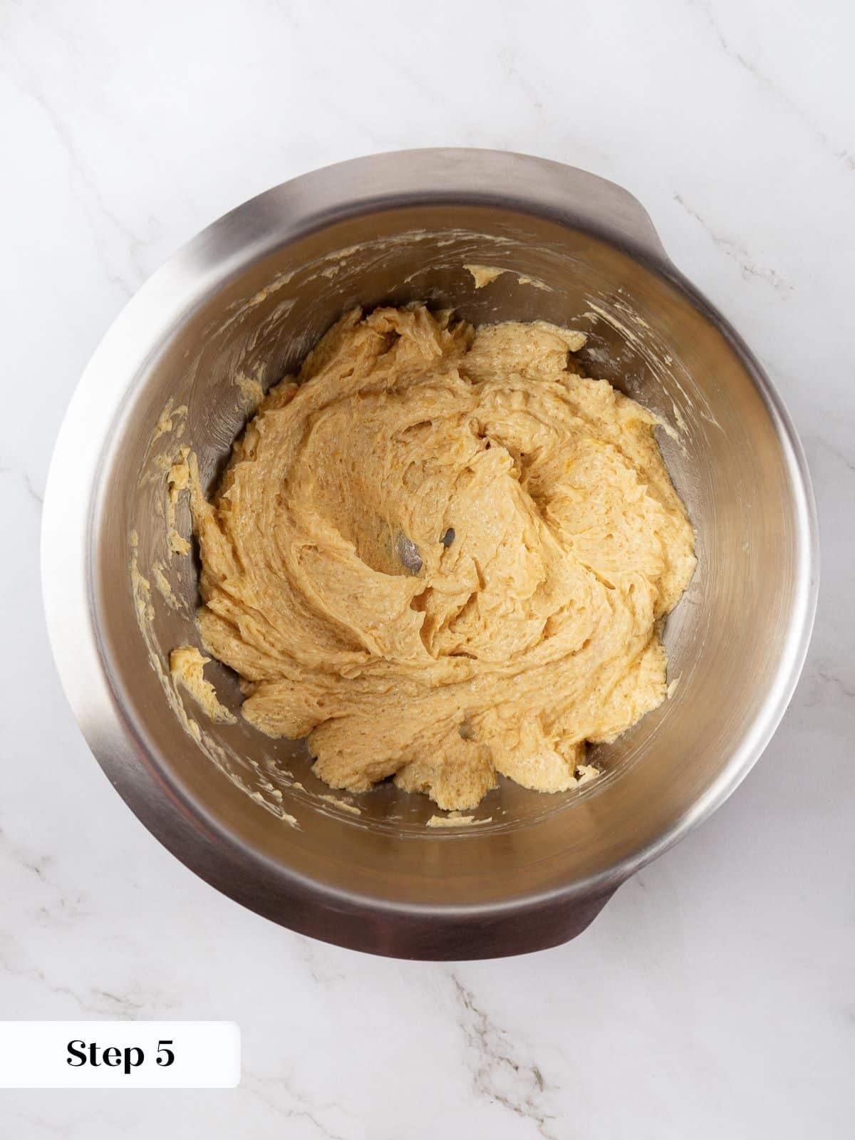 A bowl of dough with lemon juice just added and mixed.