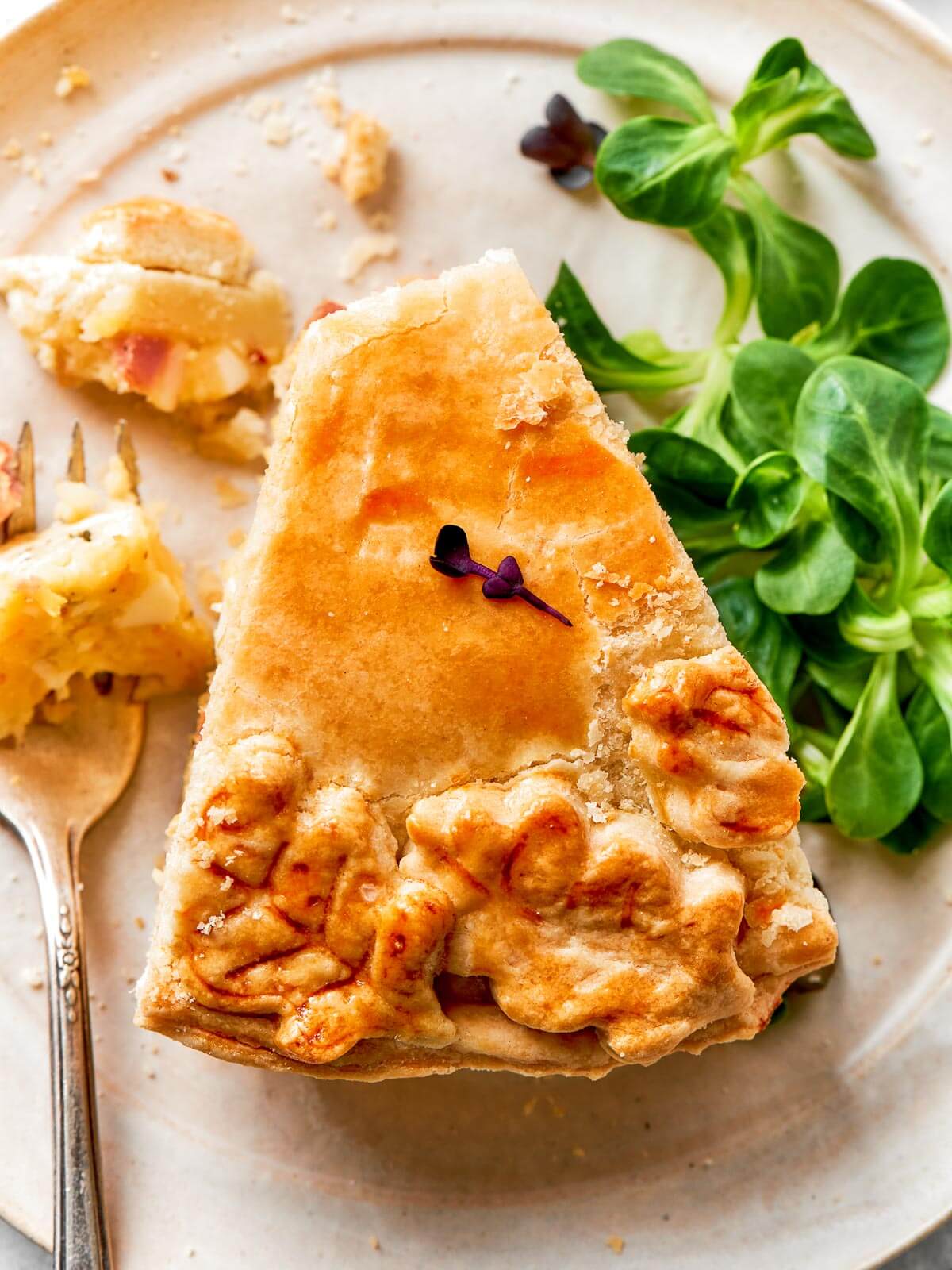 An elegant pizza rustica with a decorative pastry top, baked to perfection.