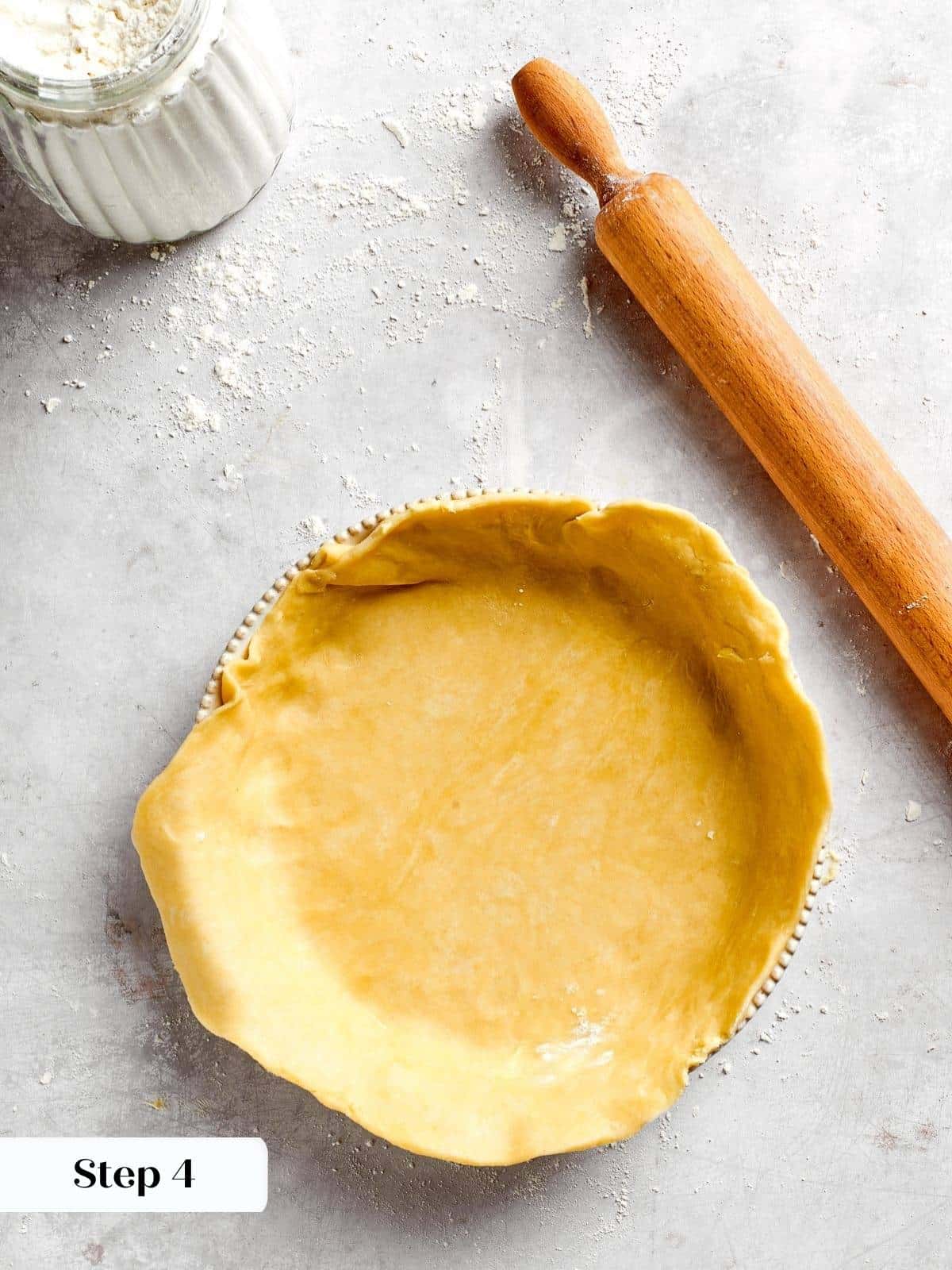 The bottom pastry crust lining the springform pan before filling is added.