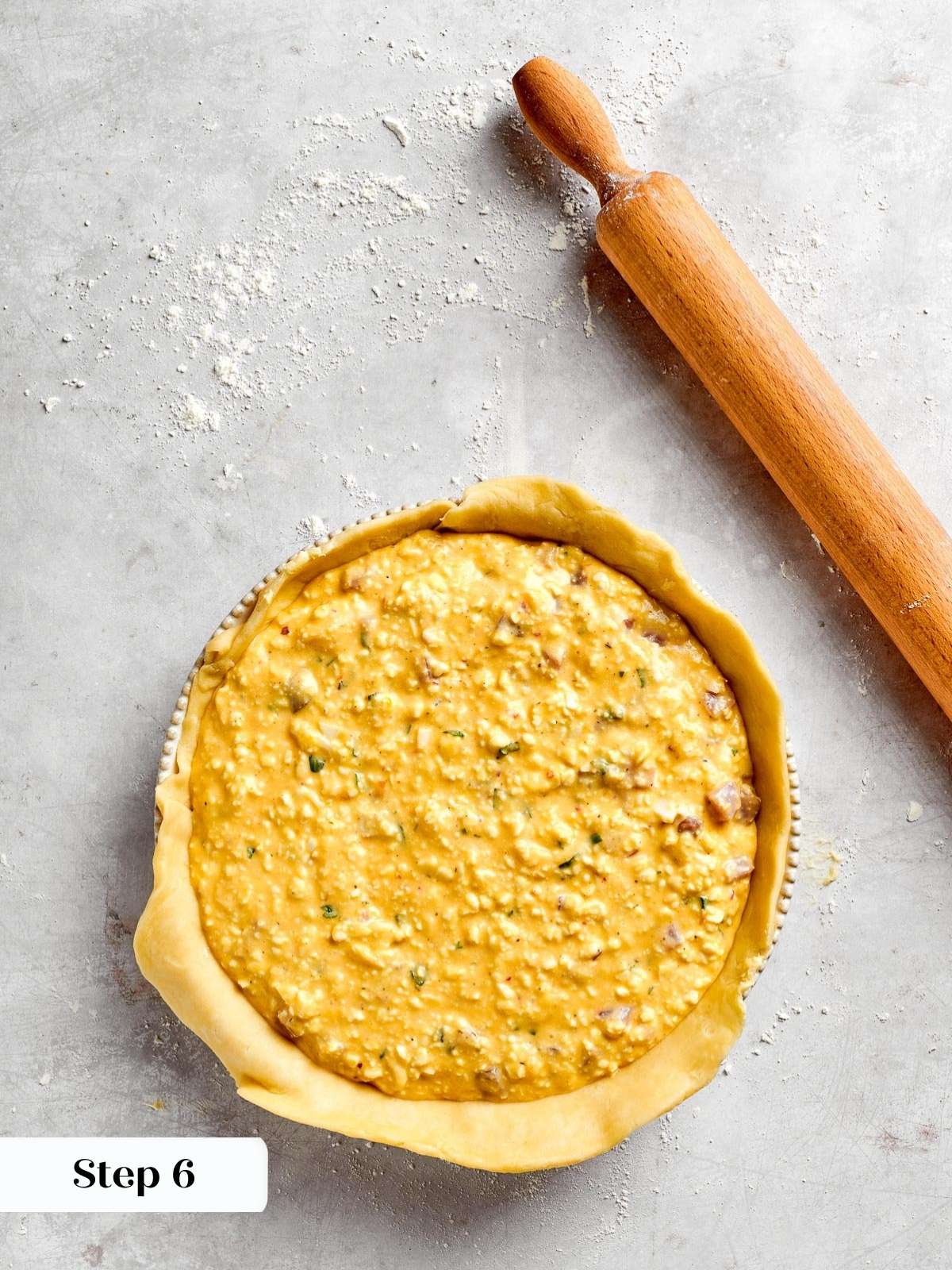 A springform pan filled with the savory ingredients of pizza rustica.