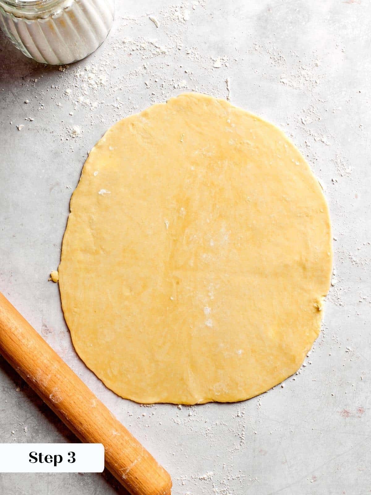 A sheet of pie dough rolled out and ready to line the pan.