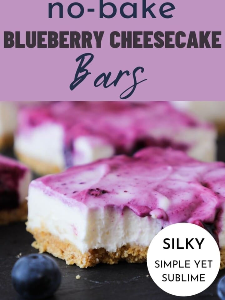 A square slice of blueberry cheesecake bar with blueberry swirl and graham crust.