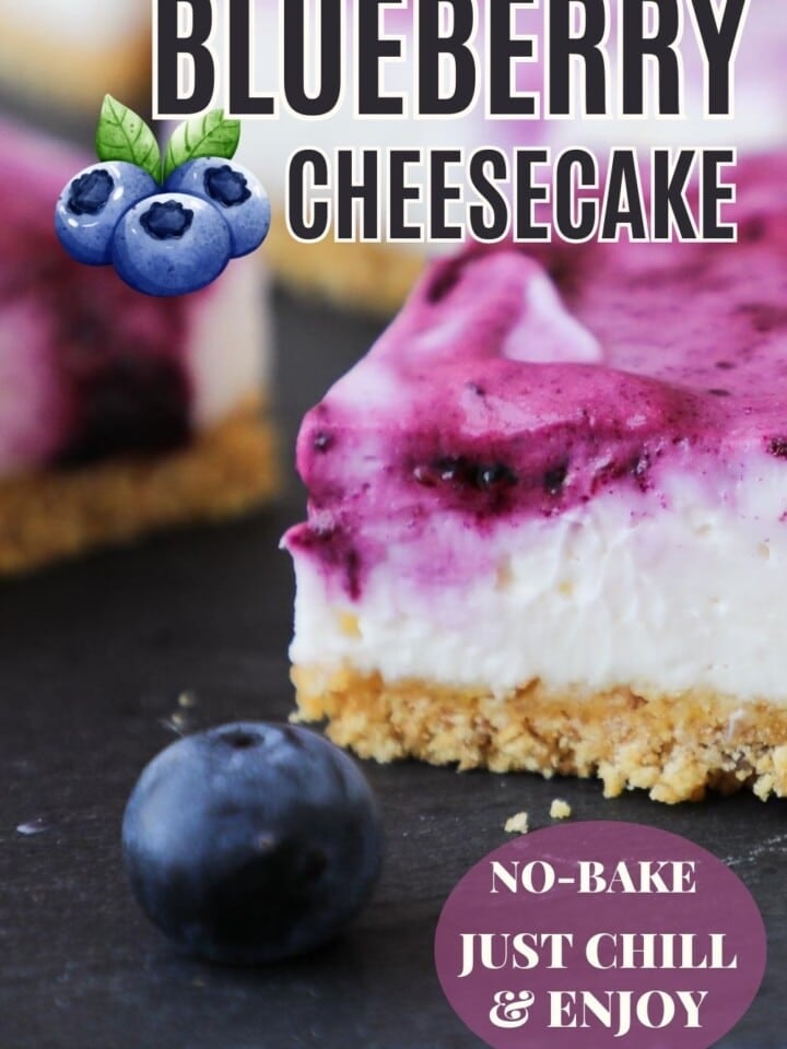 Close-up of a thick blueberry cheesecake square with a golden crust.