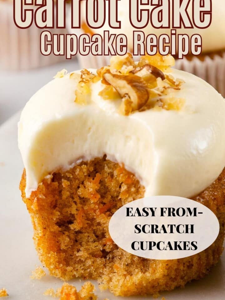Cupcake with orange flecks of carrot, golden cake, and smooth topping.
